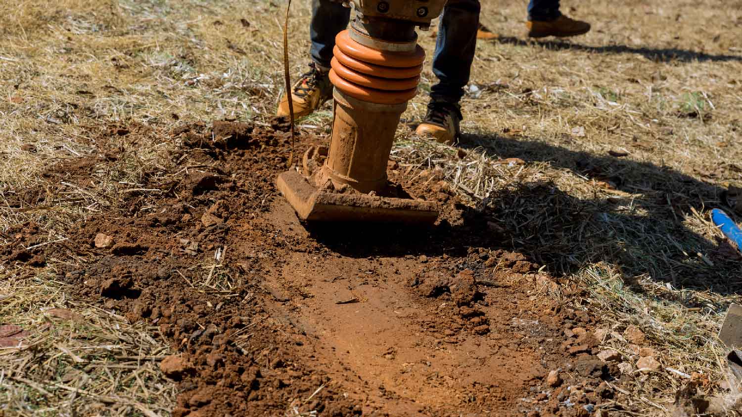 Compressing soil with a compactor