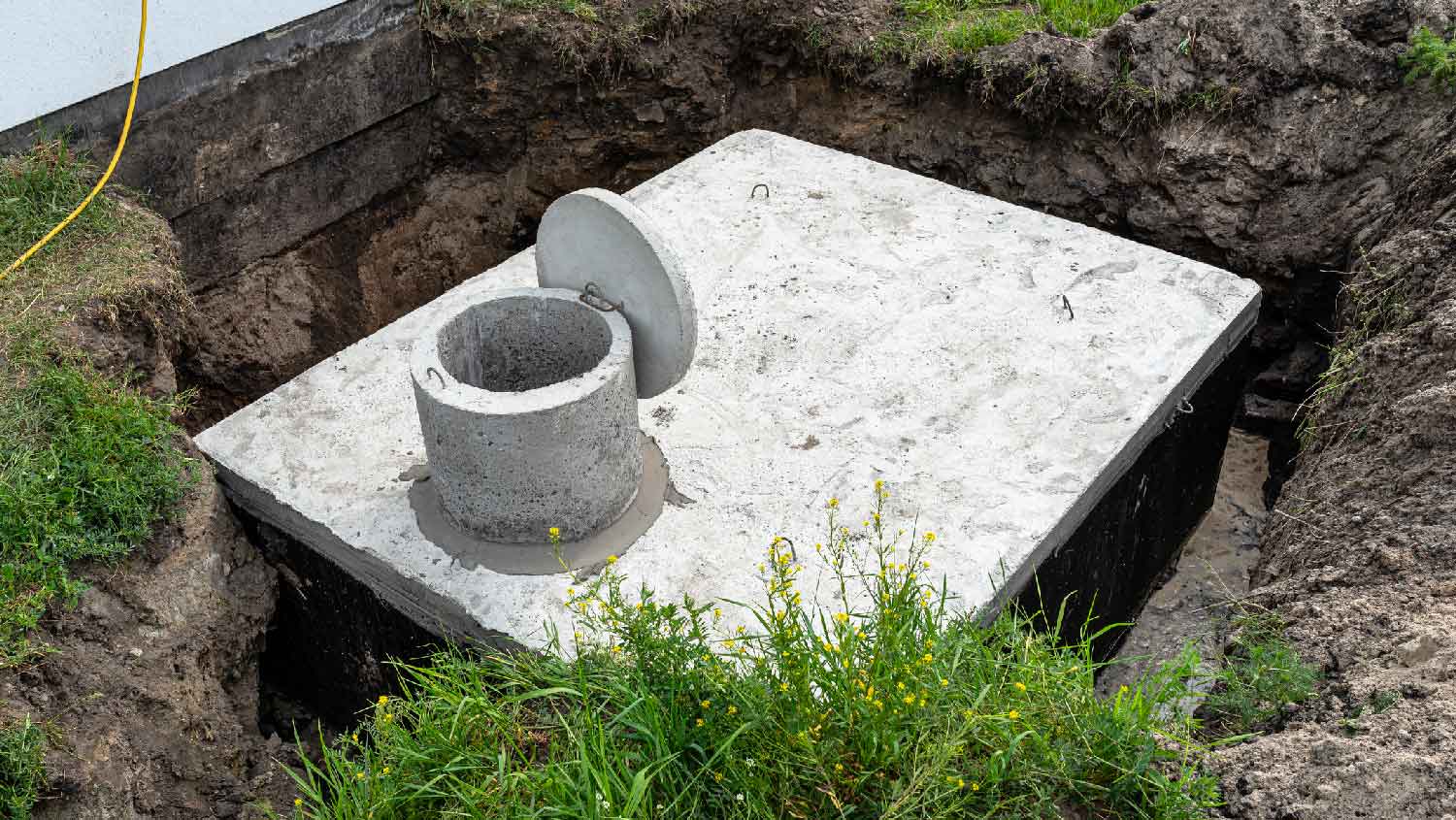 A concrete cesspool placed in a garden