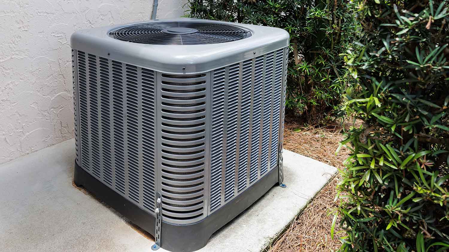 New HVAC condensing unit placed on a concrete slab