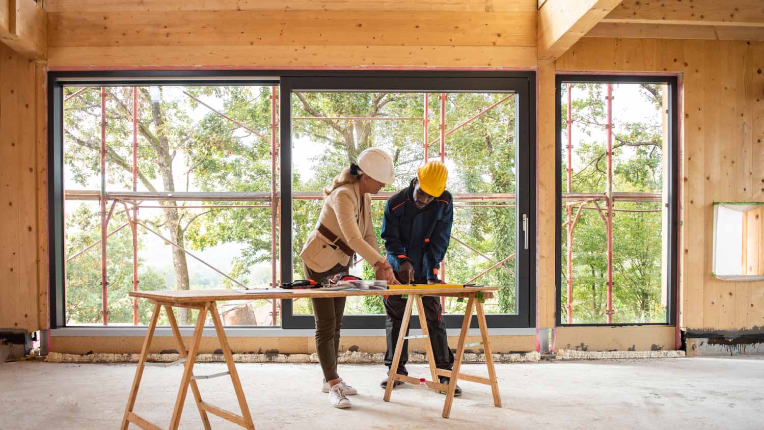 A construction manager checking the blueprints with the architect