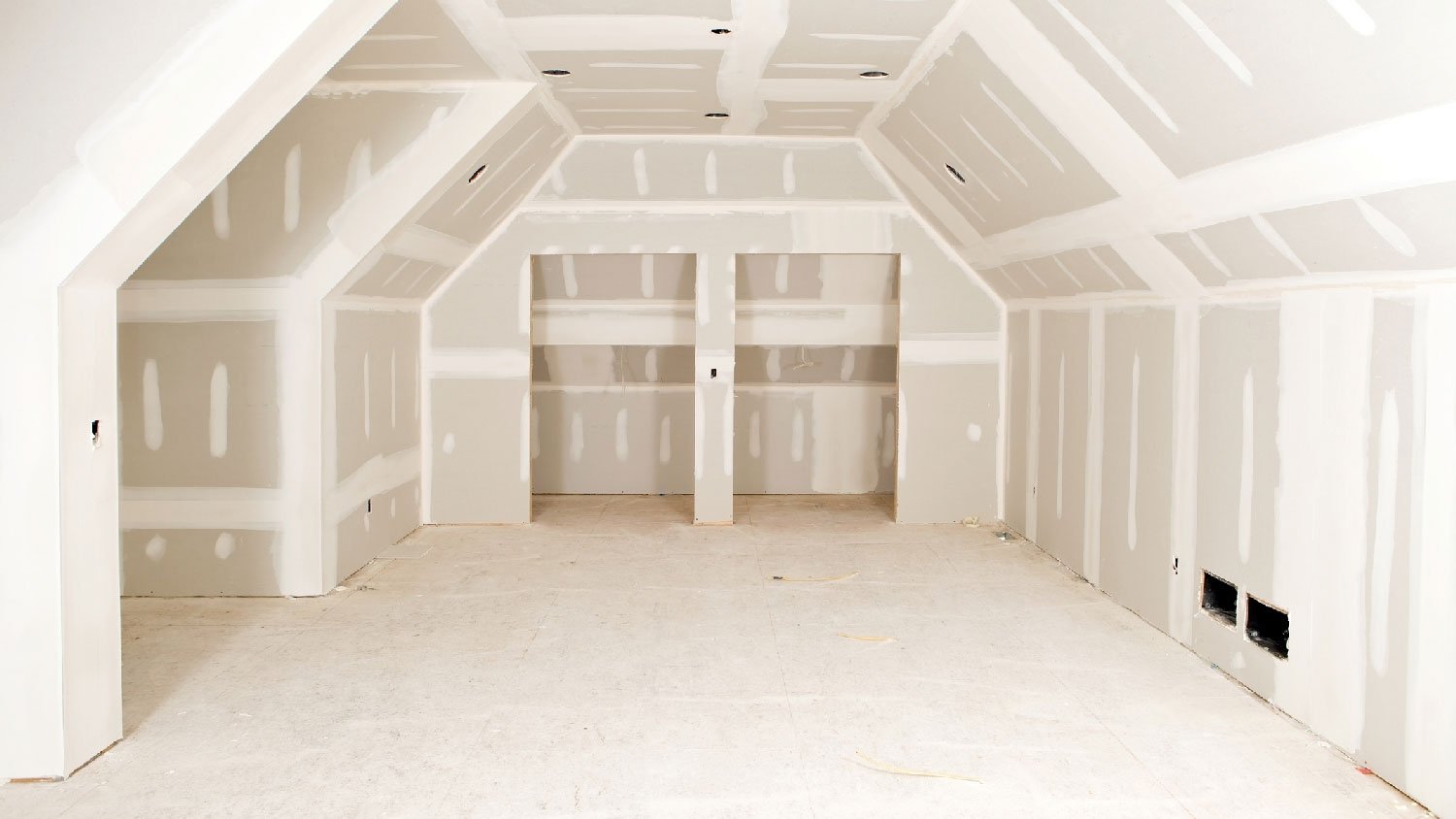 A person installing a drywall with screws