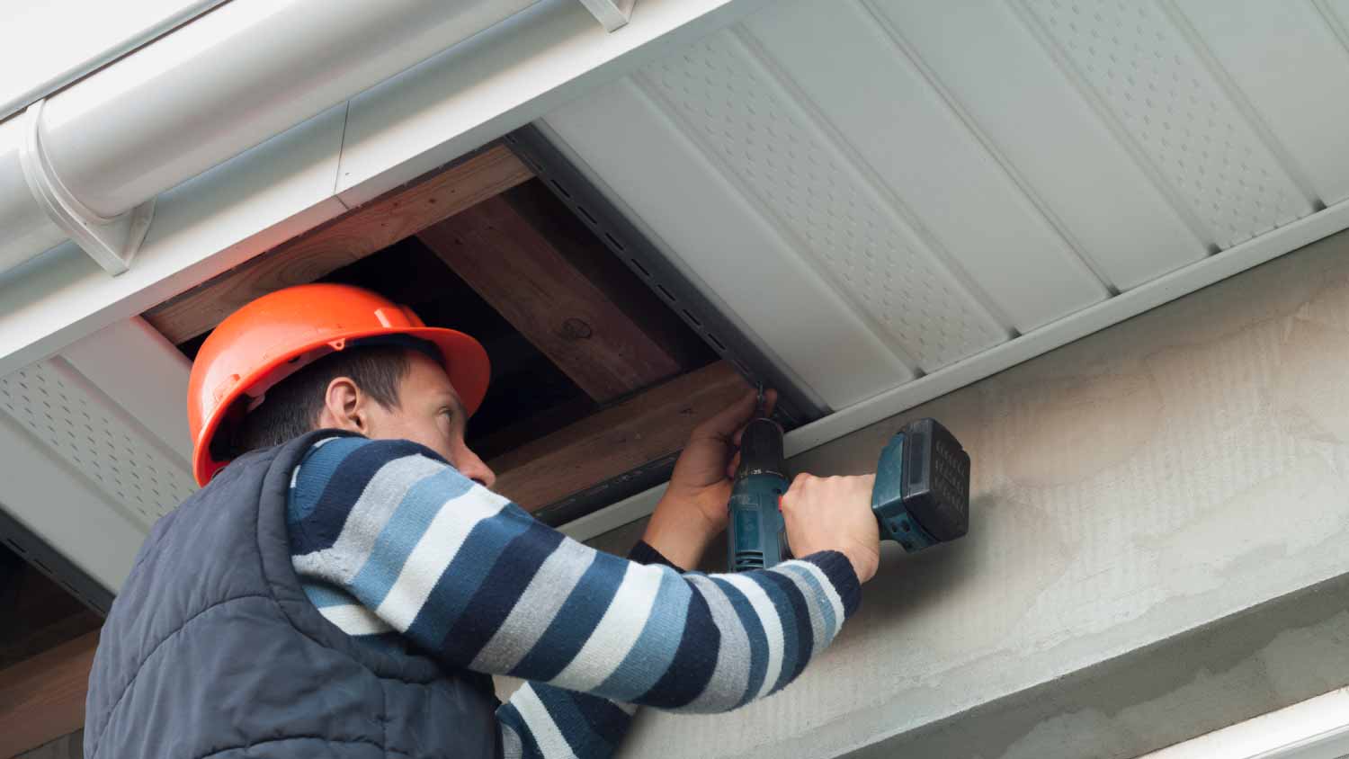 Construction worker mounting a soffit