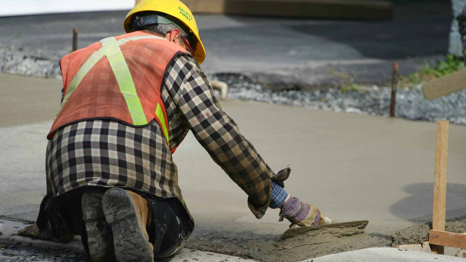 Construction worker paving with concrete 