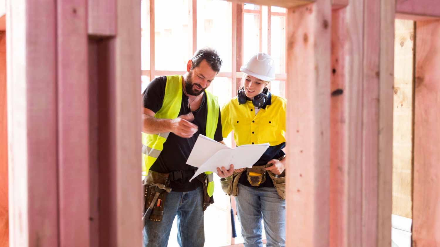 Construction workers discuss the building plans