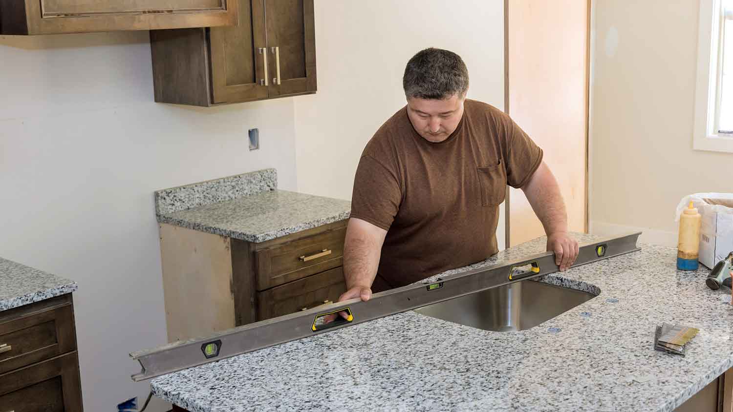 Contractor installing granite countertop in the kitchen