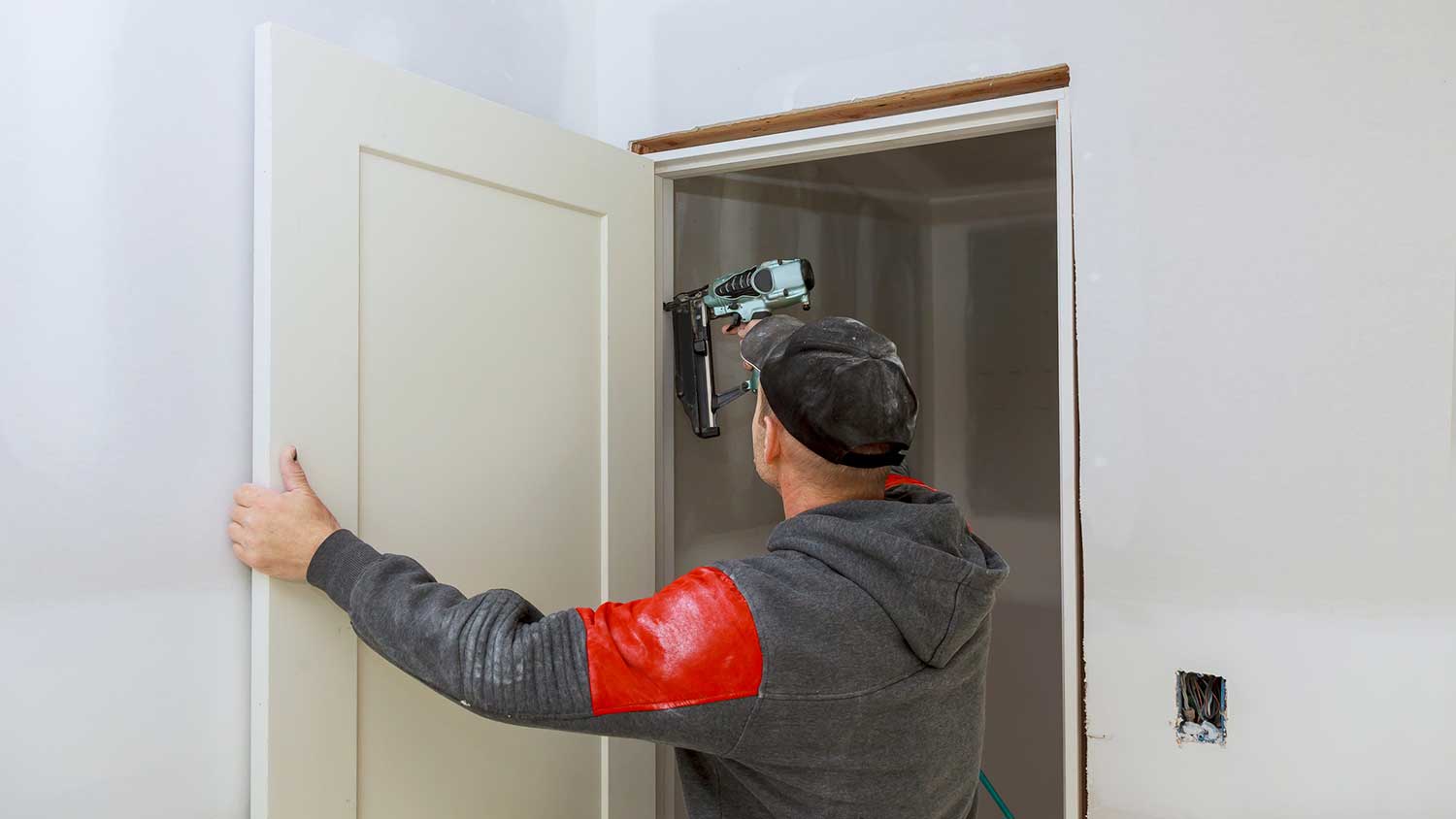 General contractor installing interior door