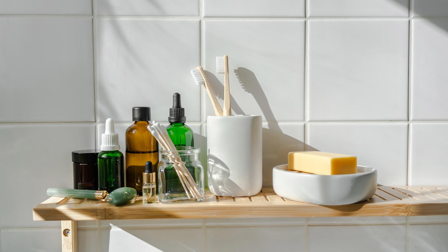 Cosmetic items and toiletries on a bathroom shelf