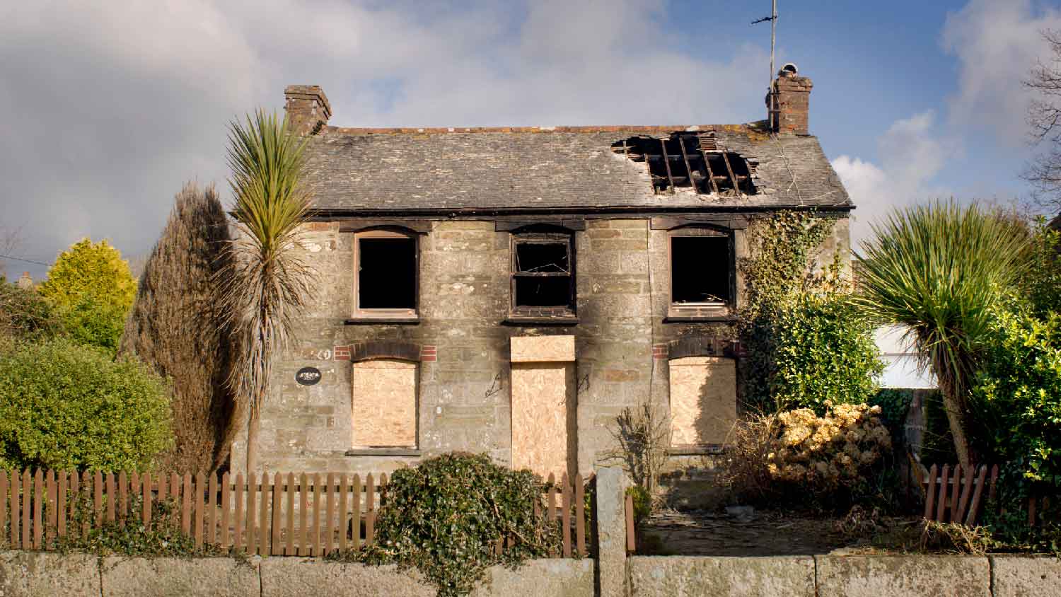 A cottage with structural damage after a fire