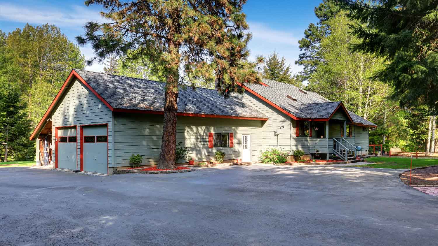 A country house with a wide asphalt driveway