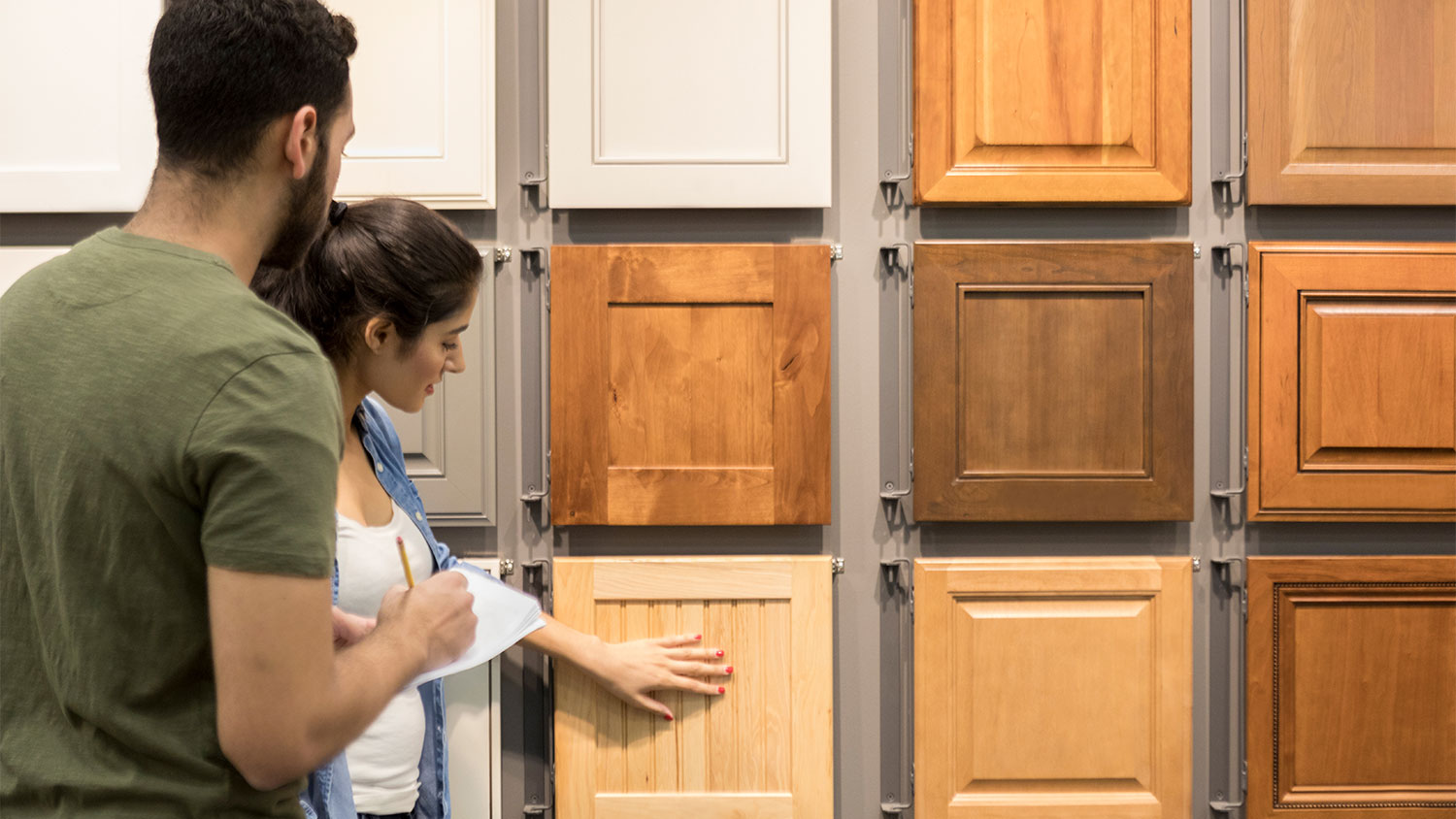 Couple looking at kitchen cabinet samples