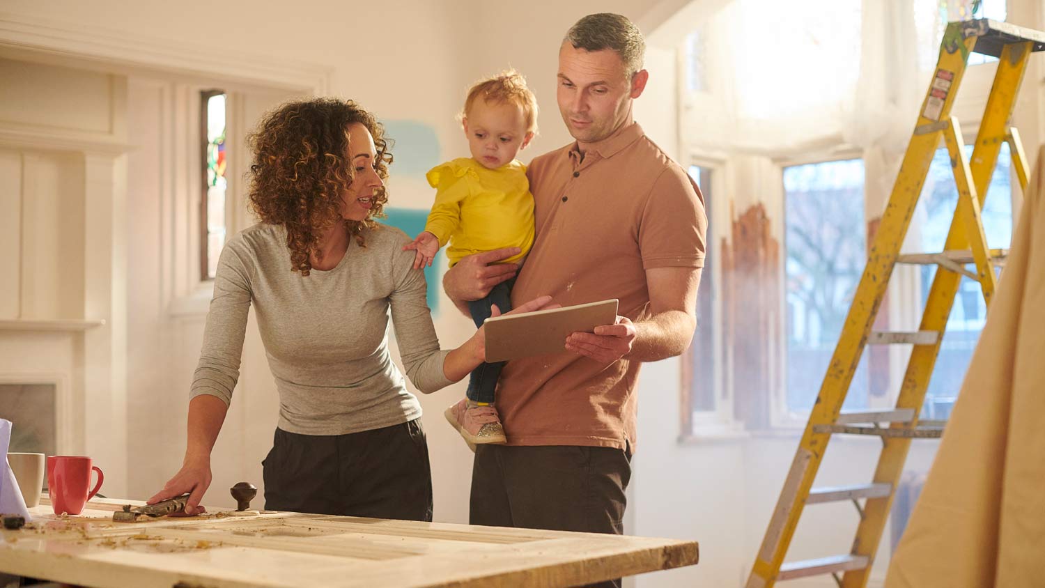 couple holding child during home reno