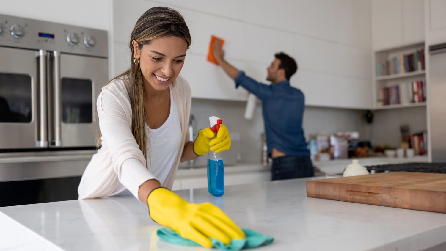 couple cleaning the kitchen together 