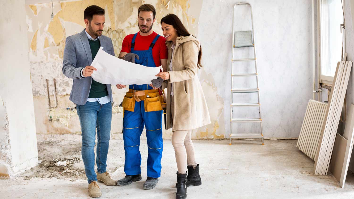 couple talking to contractor renovating home 