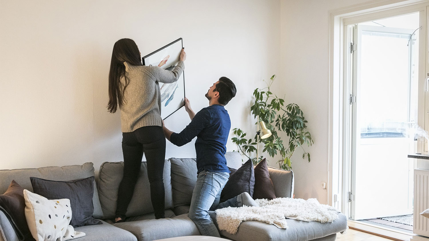 A couple decorates a house