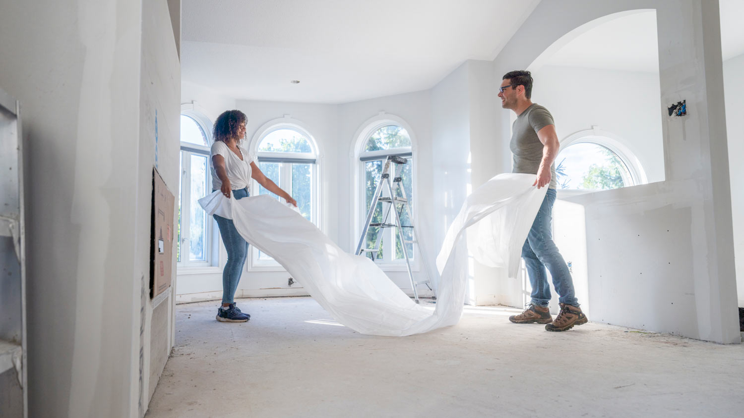 couple laying out drop cloth 