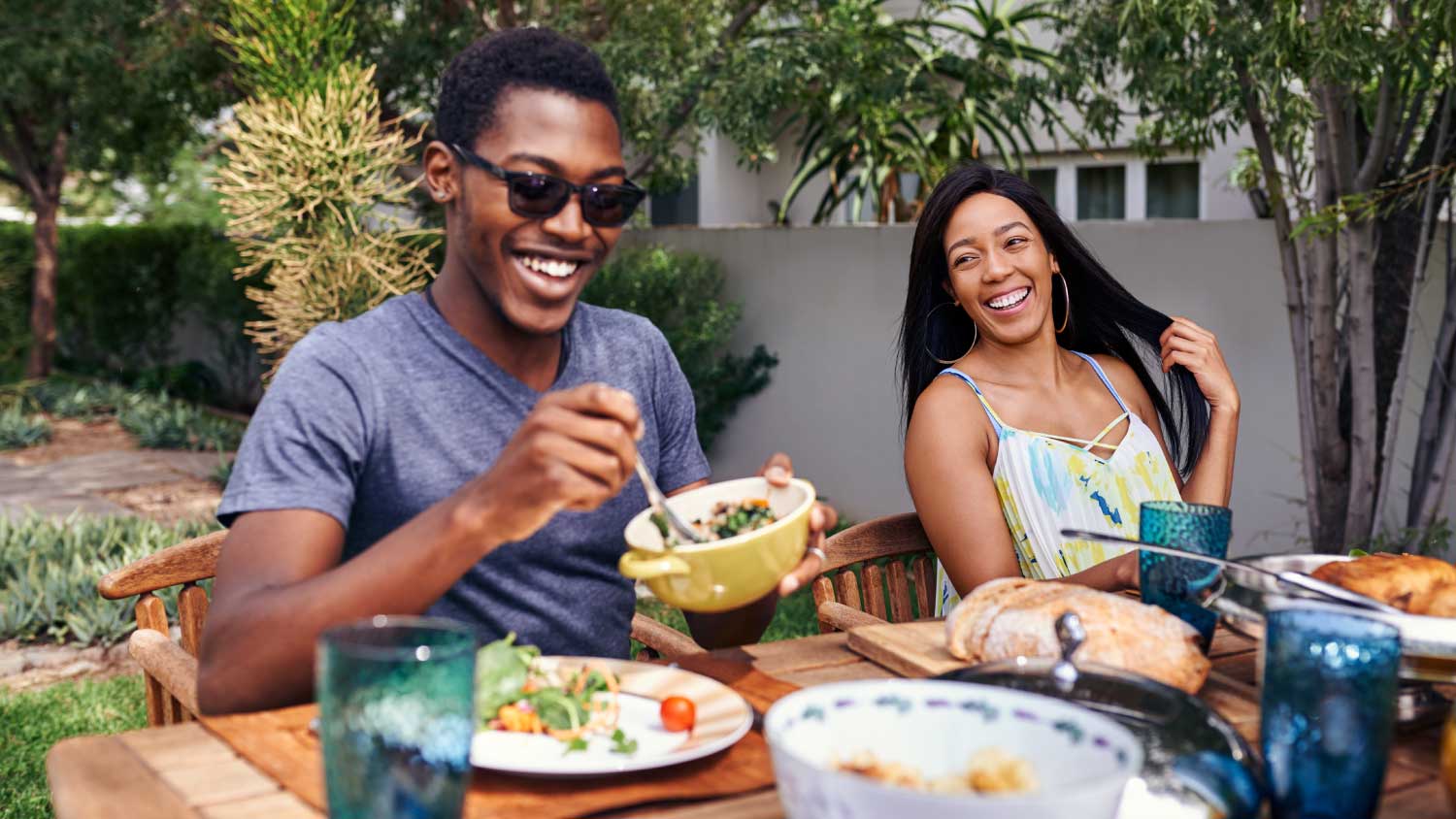 friends laughing and eating outside