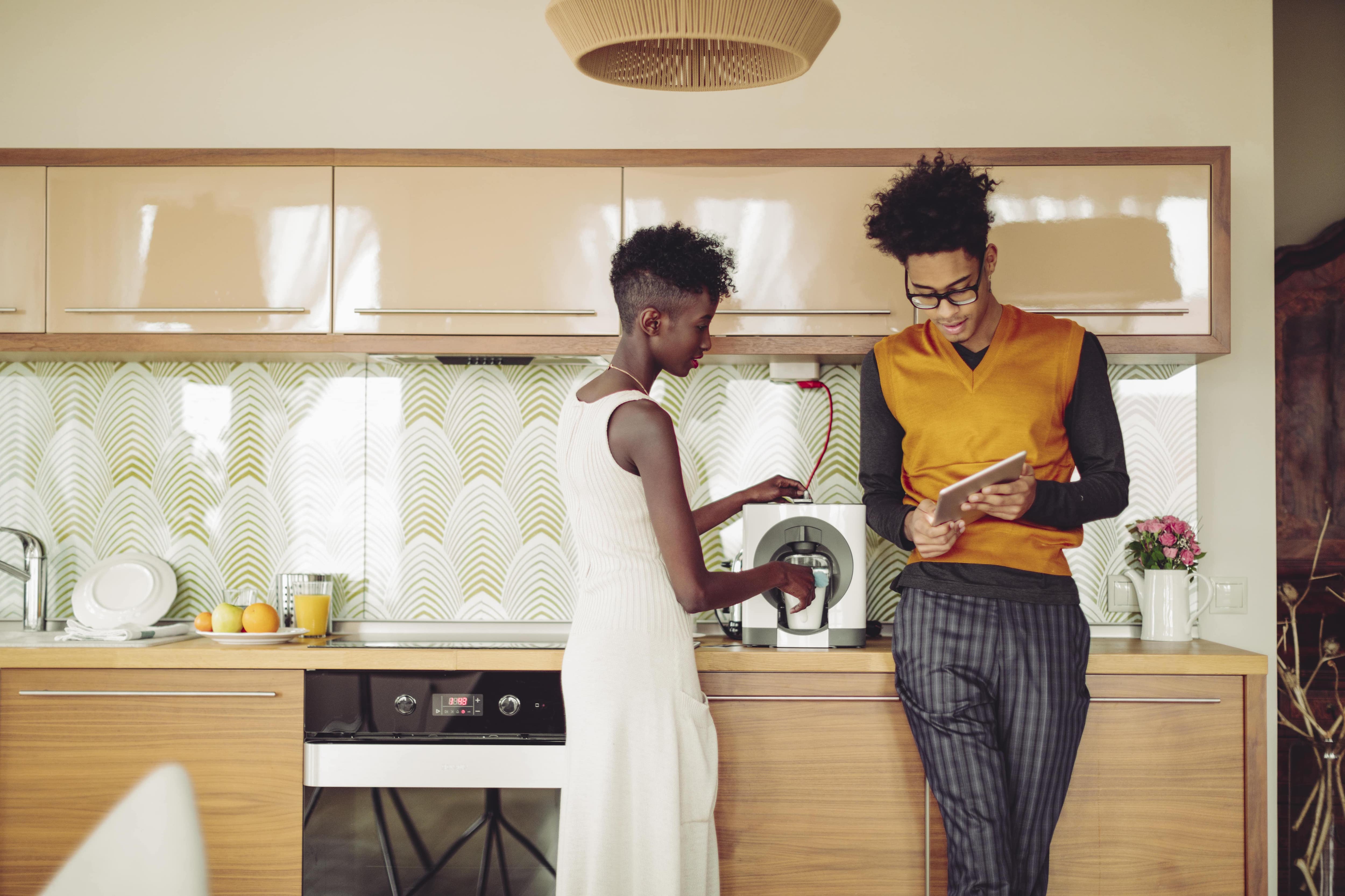 Couple making coffee in kitchen 