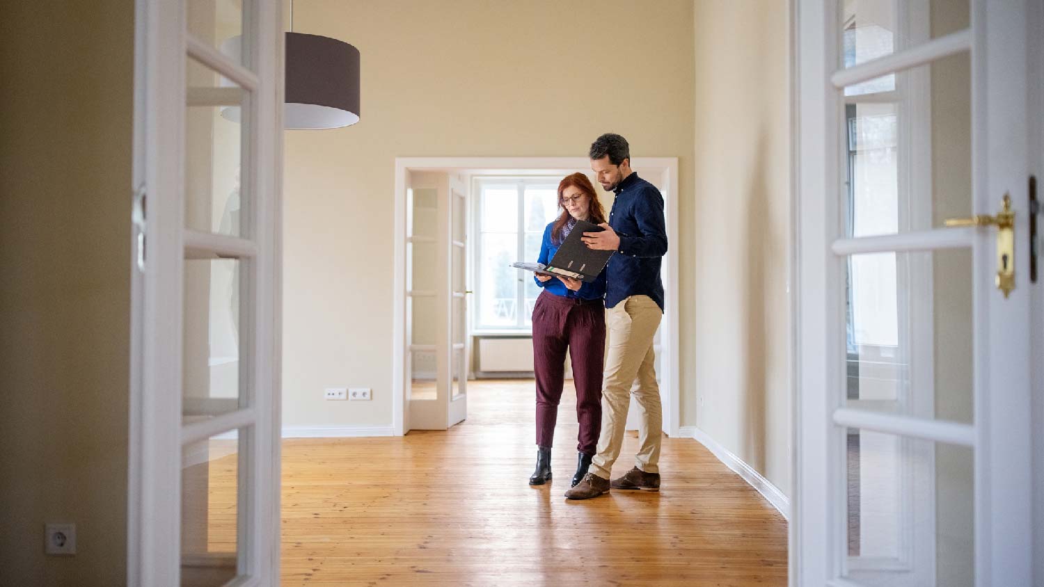 A couple inspecting documents for a house