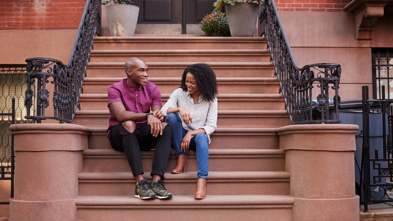 Couple talking and laughing on stoop