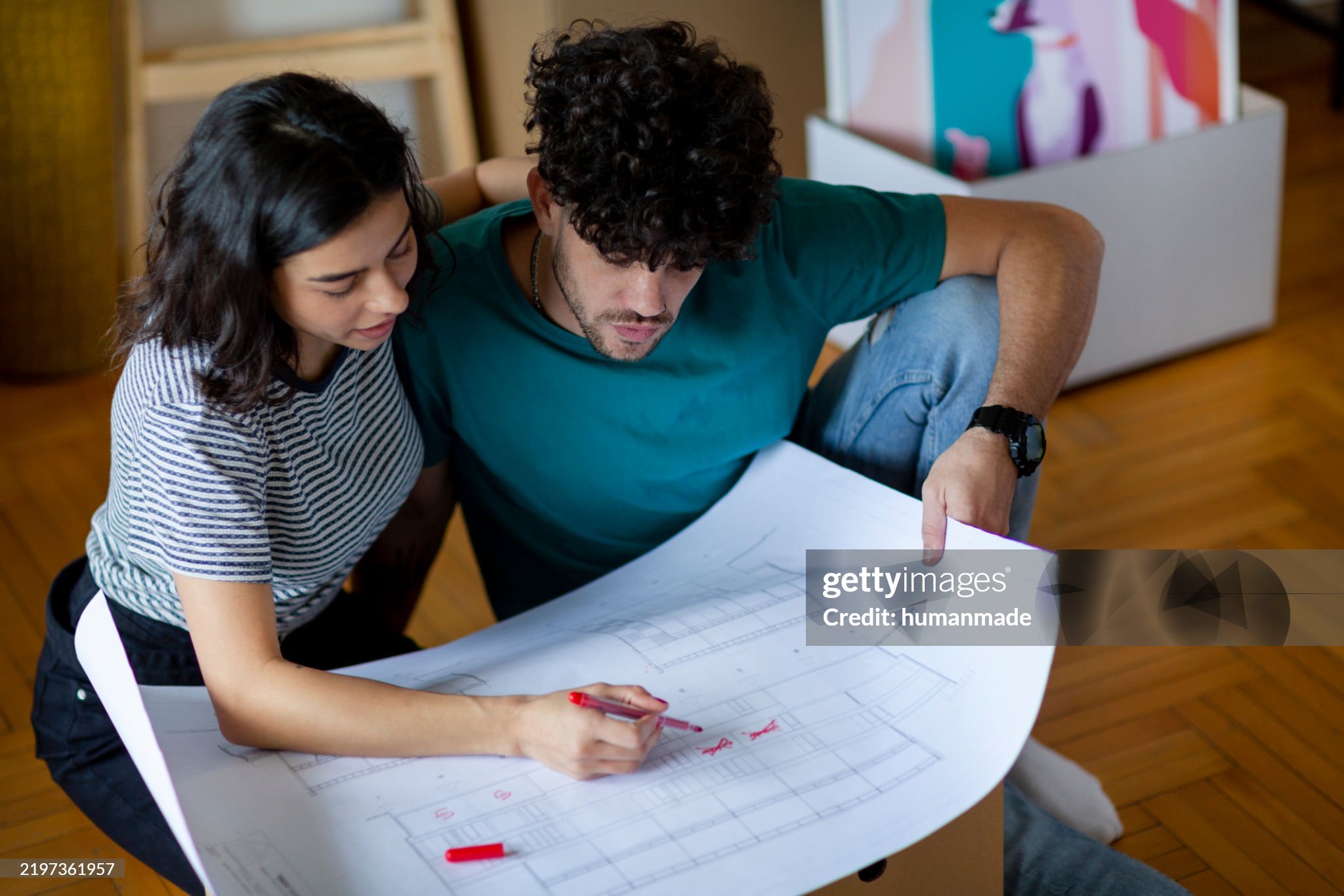 A couple looking at the blueprints of their home