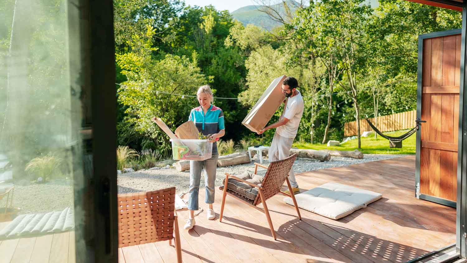 Couple putting patio furniture away for the season