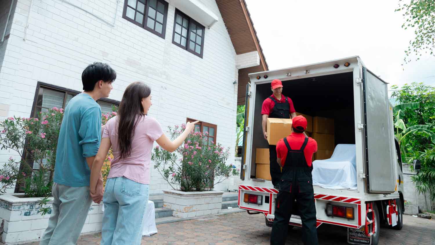 couple and professional movers