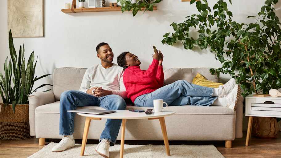 A couple relaxing on their sofa
