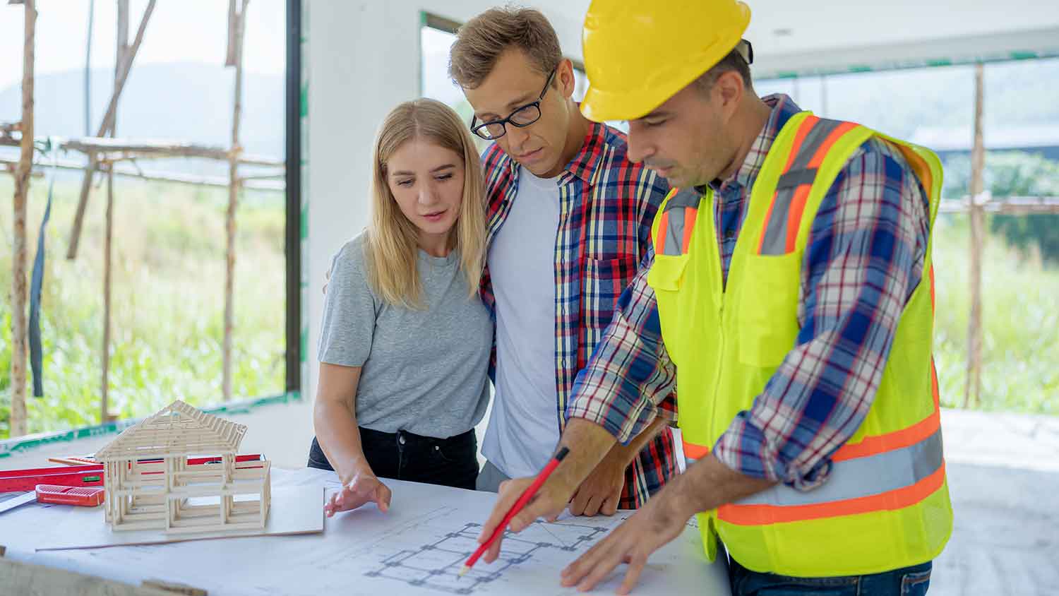 Builder and clients reviewing new house floor plan