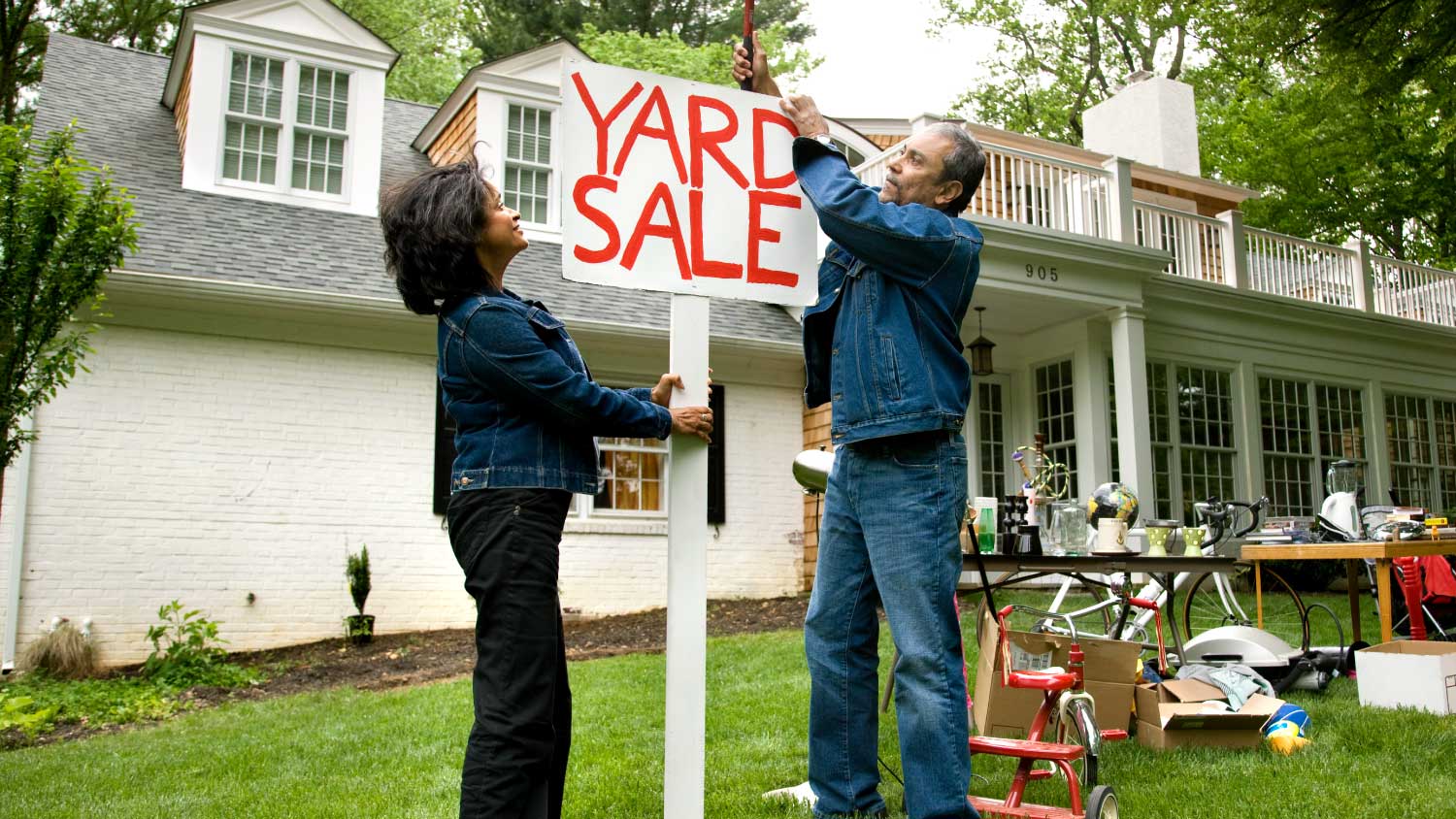 couple setting up yard sale