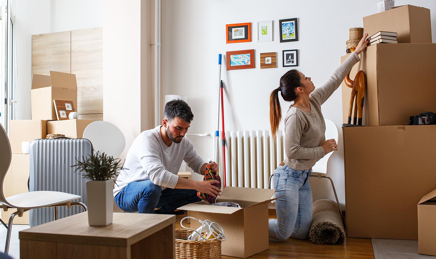 Couple unpacks moving boxes at new home