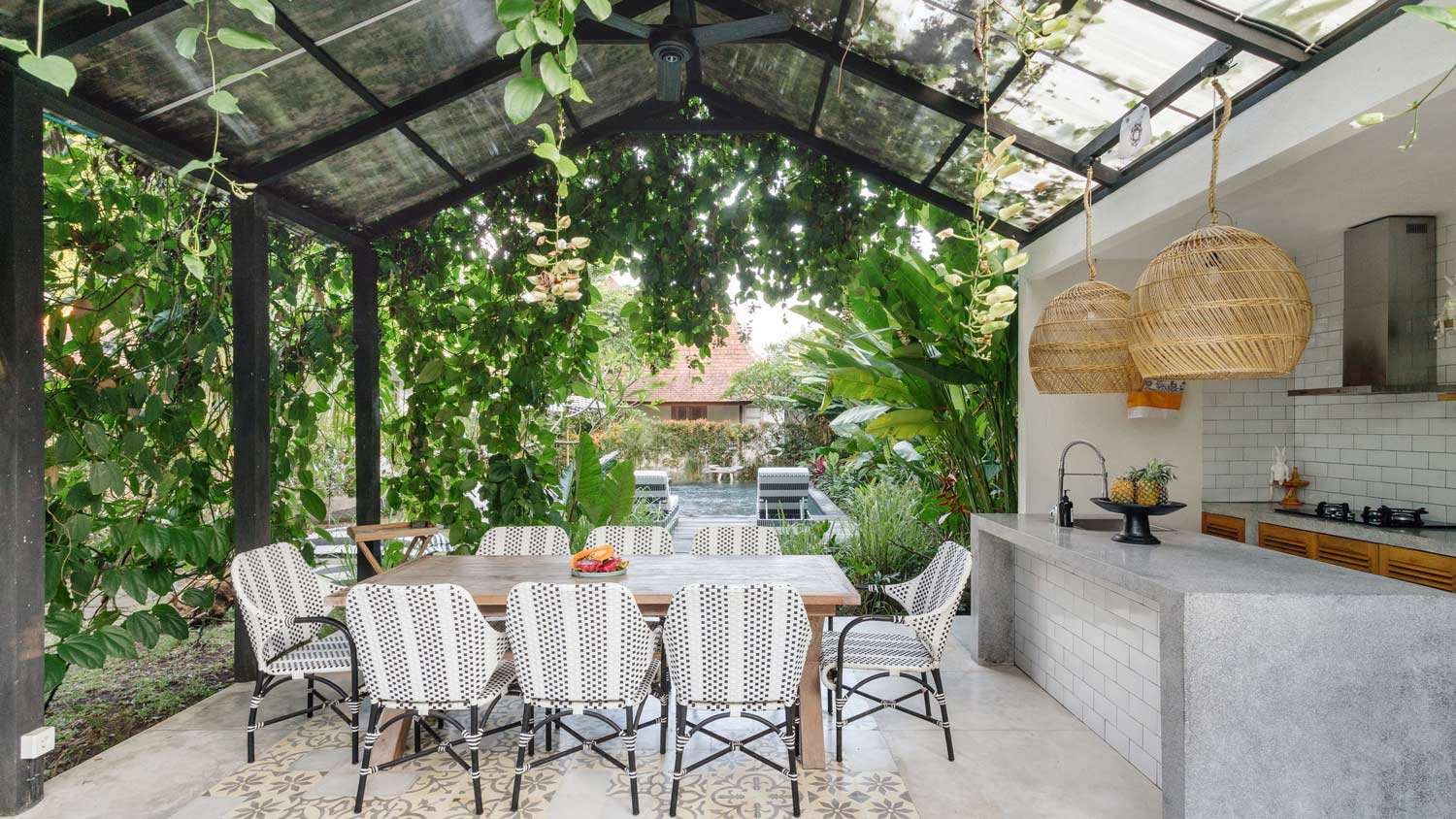 Open kitchen with empty dining room table and chairs outside