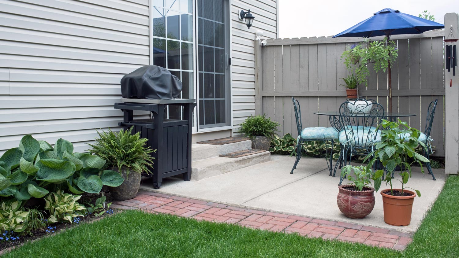 A cozy patio in the backyard of a fiber cement siding house