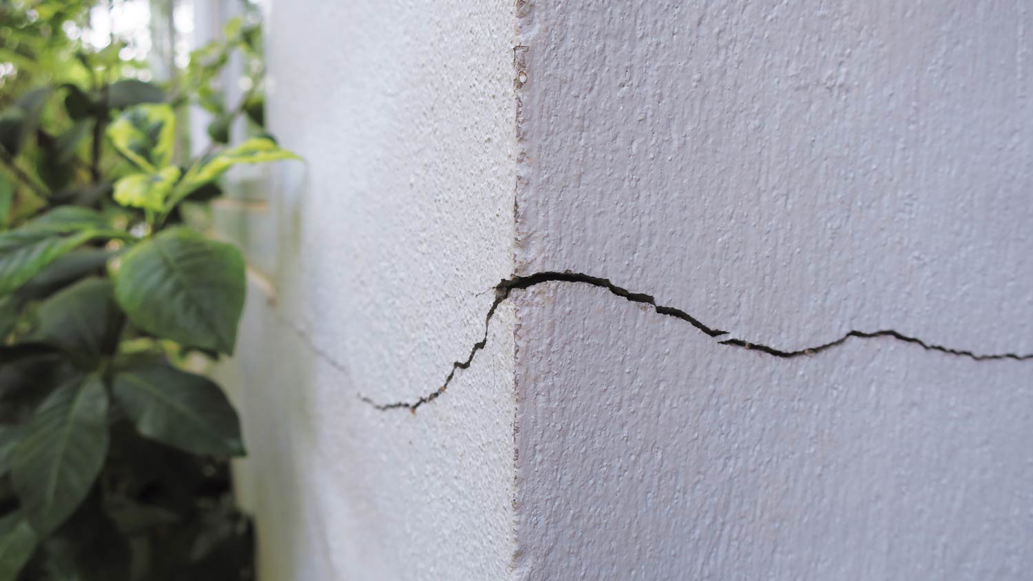 cracked concrete corner of home