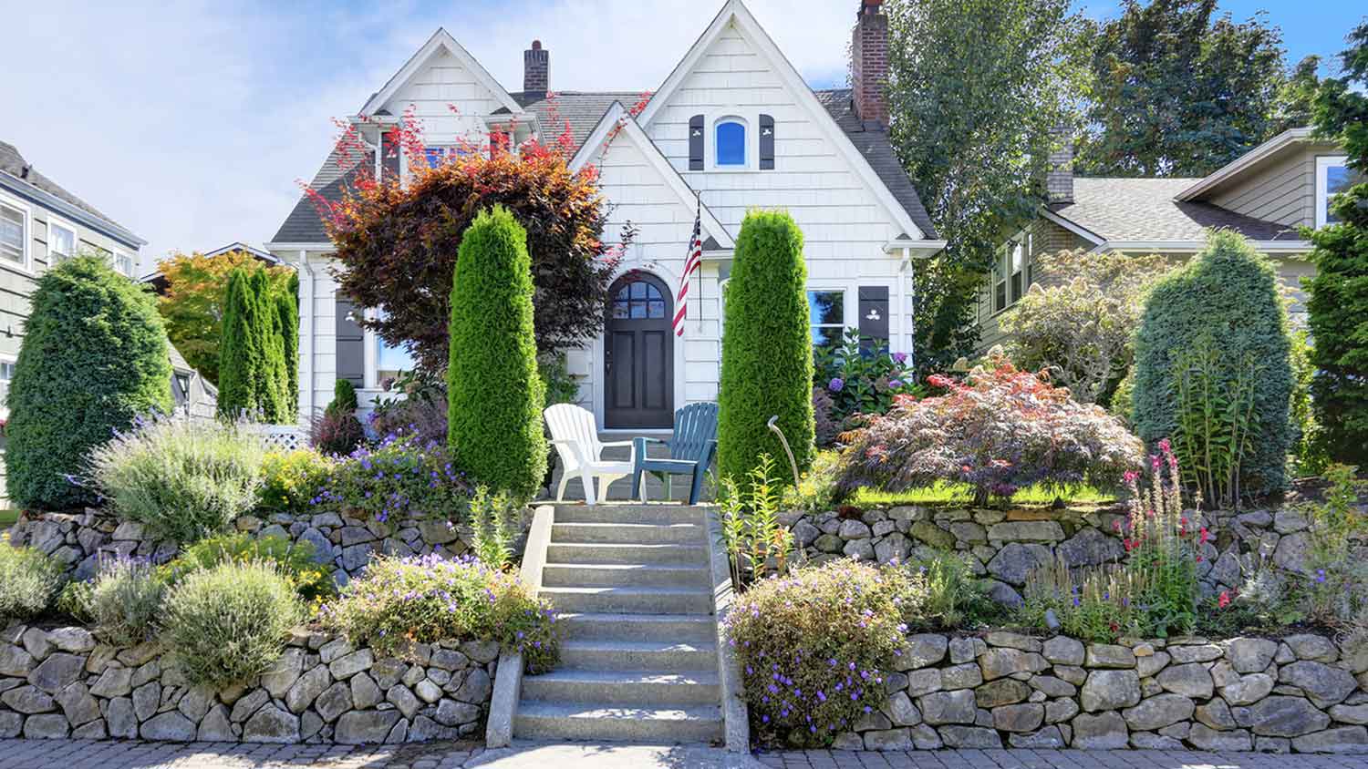 Craftsman style house exterior with stone retaining walls