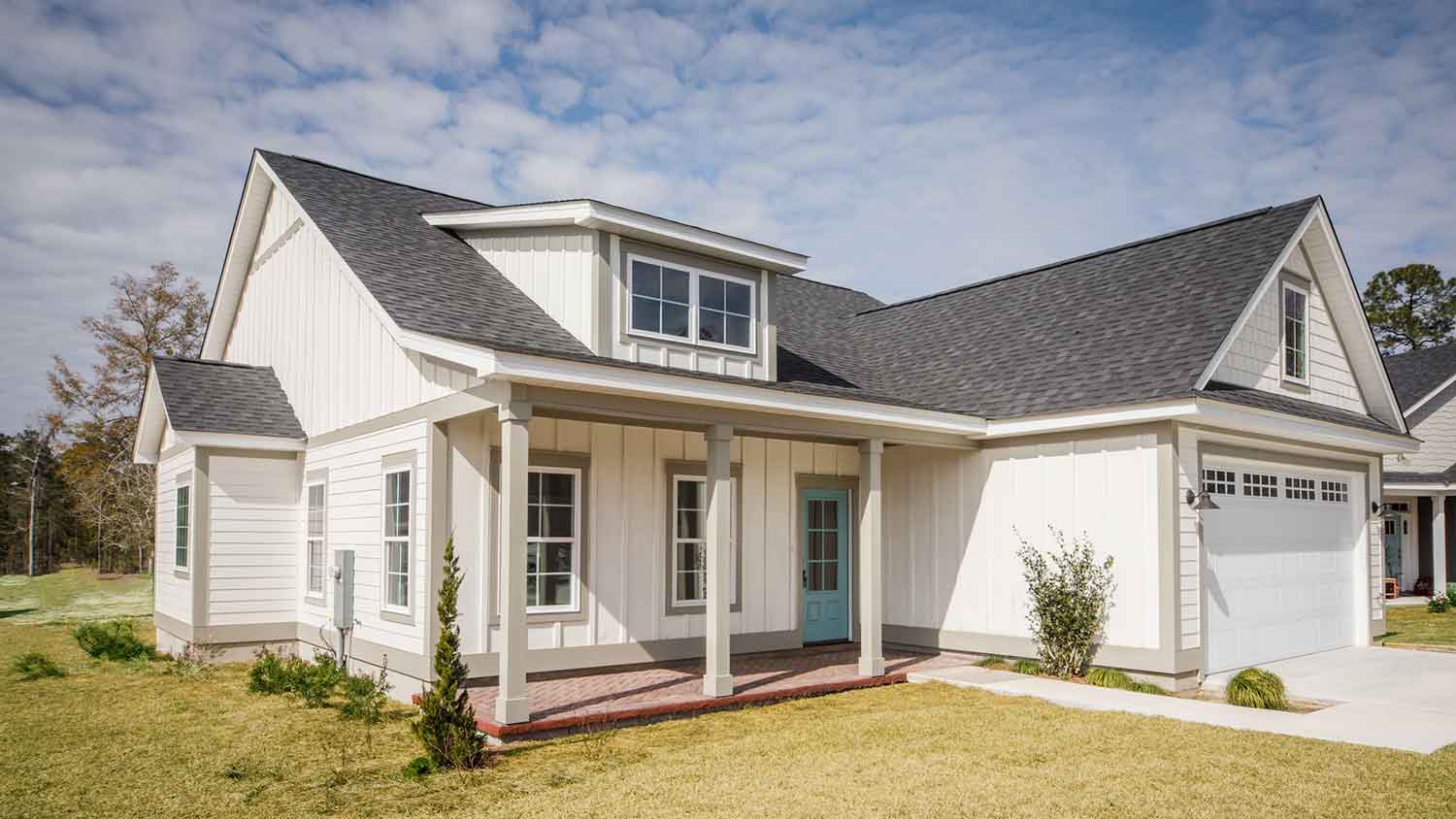 Modern home with cross gable roof and dormer window