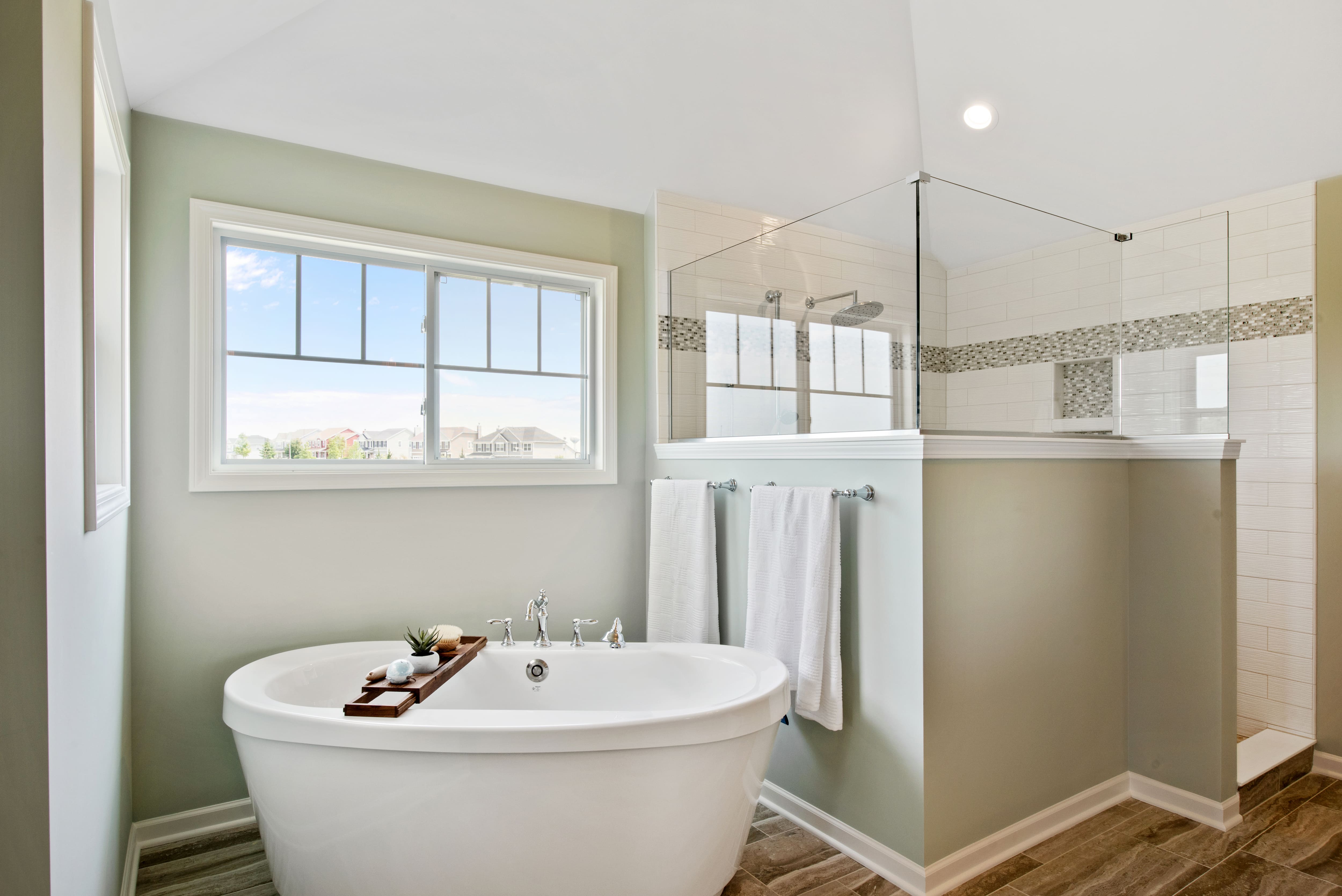 A partial shower wall decorated with crown molding 