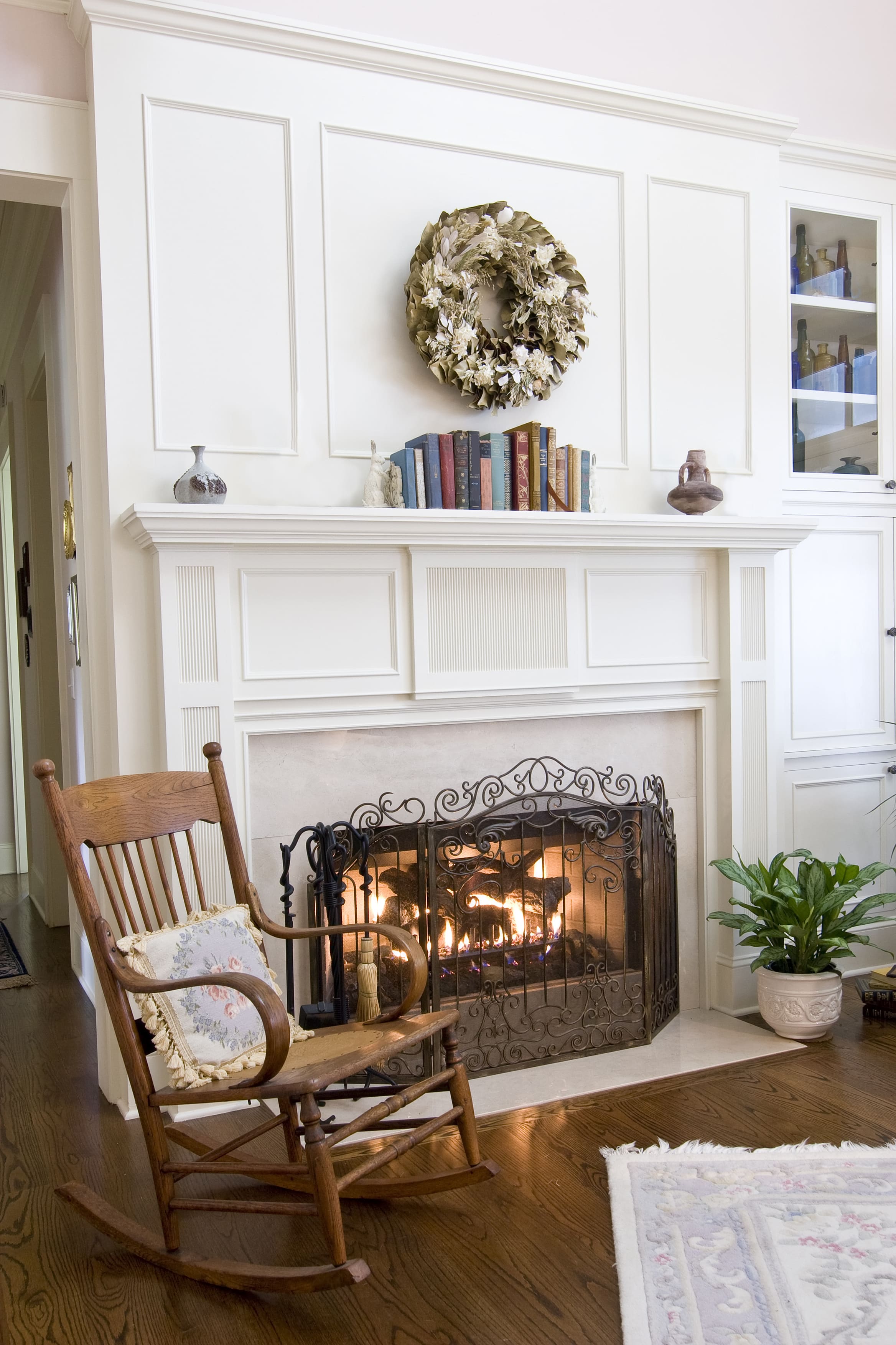 A white fireplace shelf made from crown molding