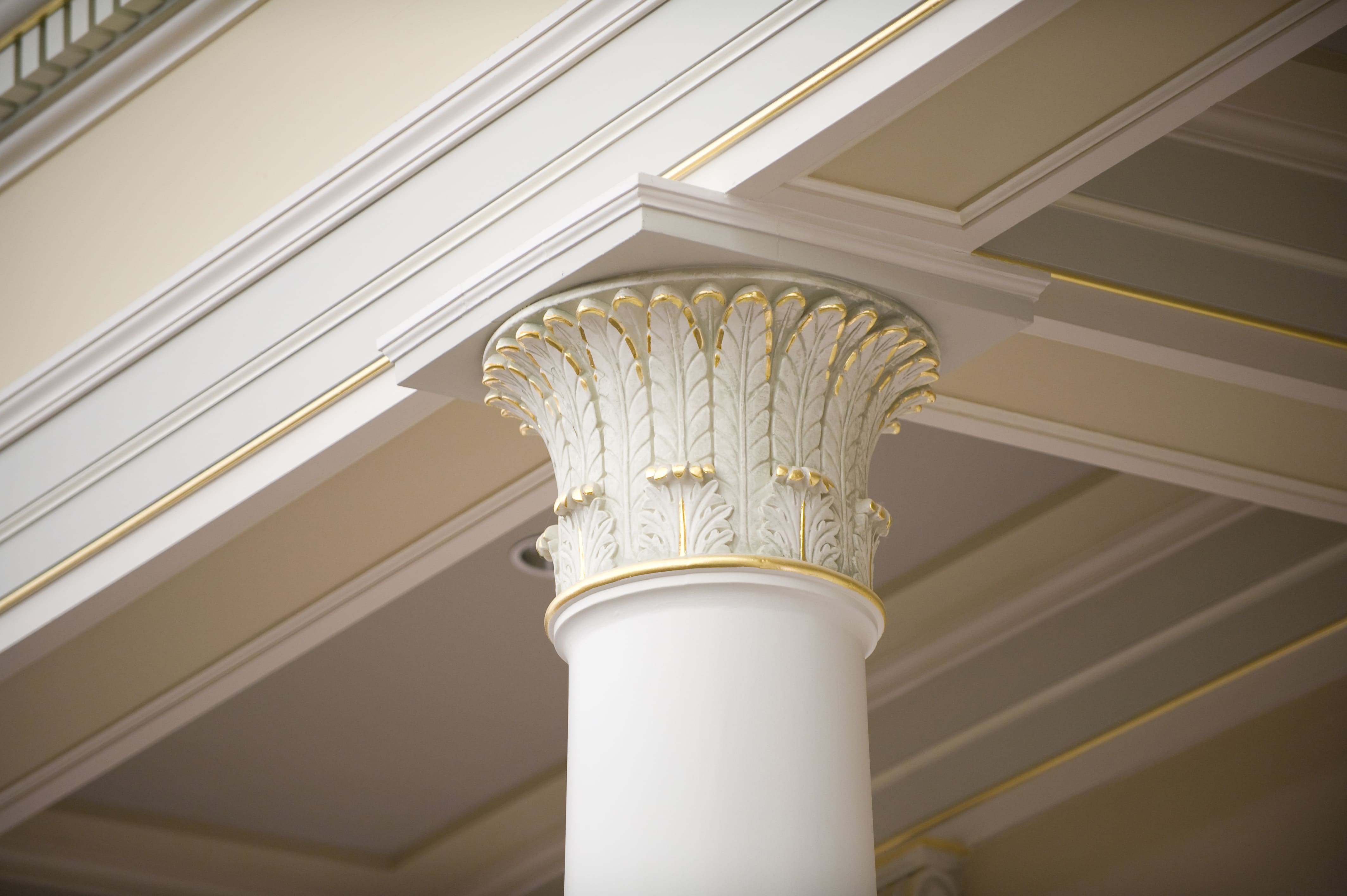 White crown molding with gold accent woven in