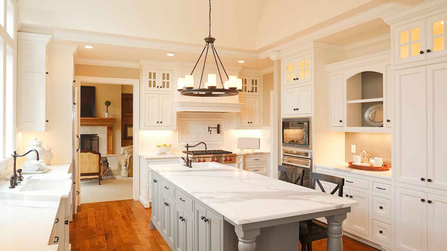 Crown molding installed on white kitchen cabinets
