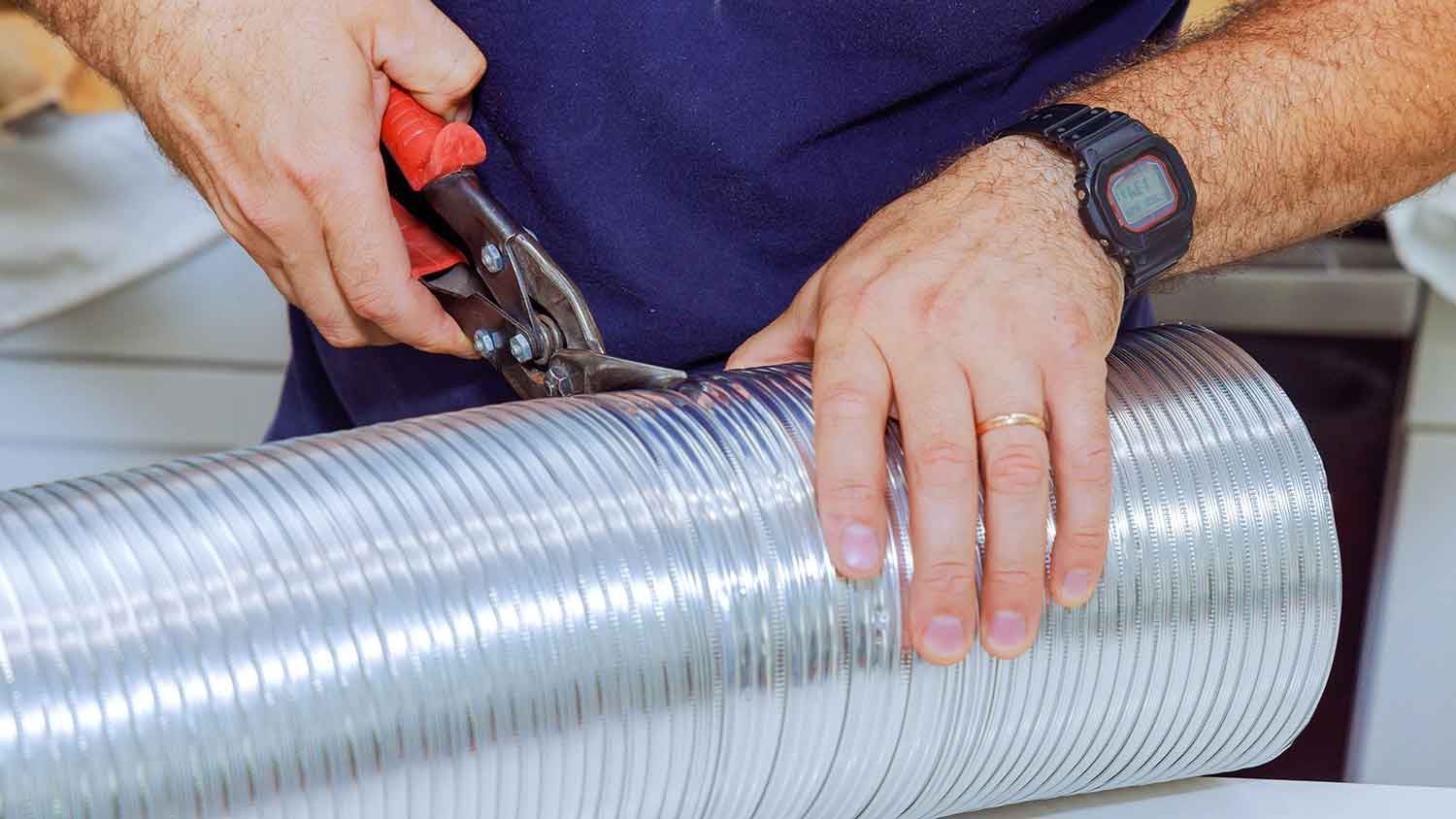 Man cutting flexible duct pipe 