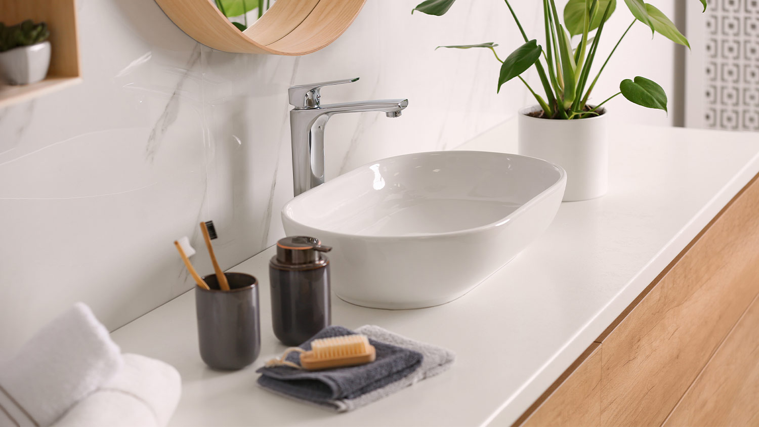 dark brown soap dispenser and toothbrush holder in a white bathroom