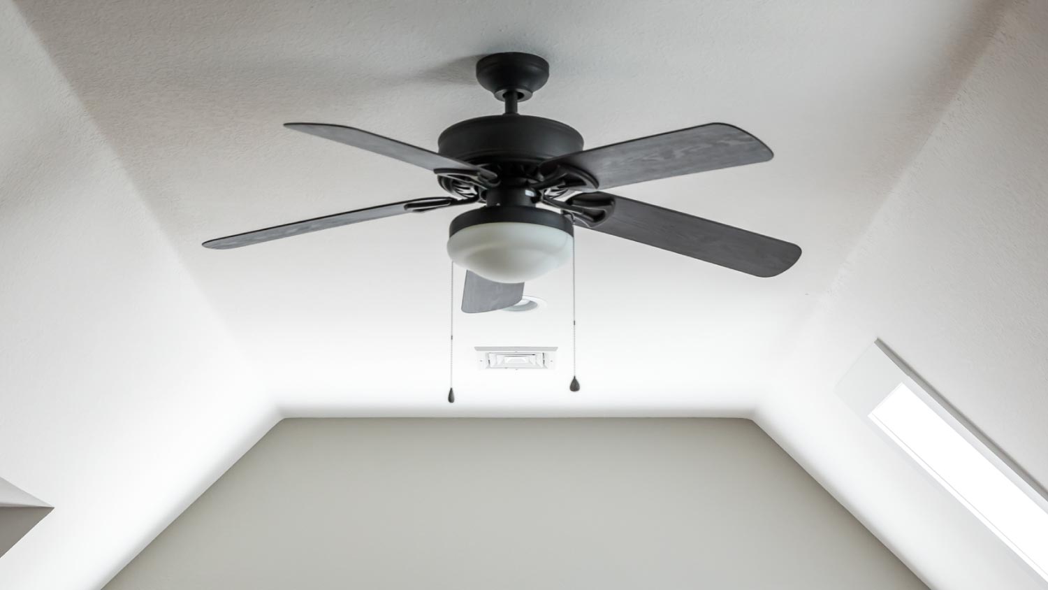 A dark wood ceiling fan