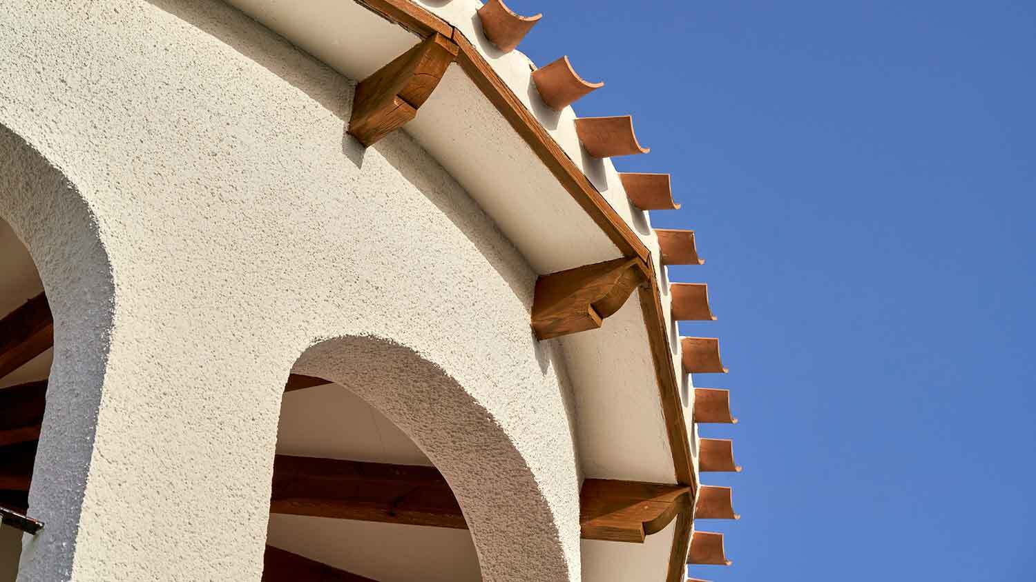 Detail of a building with arches and dash stucco finish