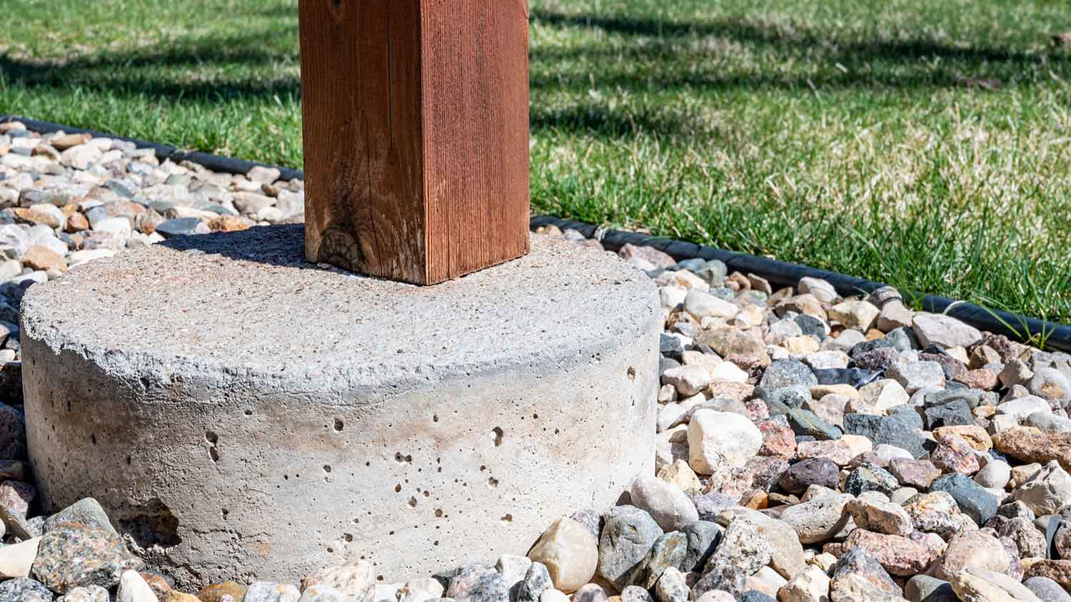 Closeup of a deck footing made from concrete