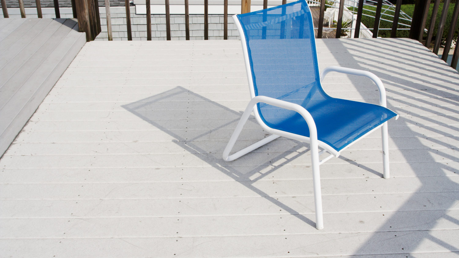 Blue Chair on gray pvc deck surface.