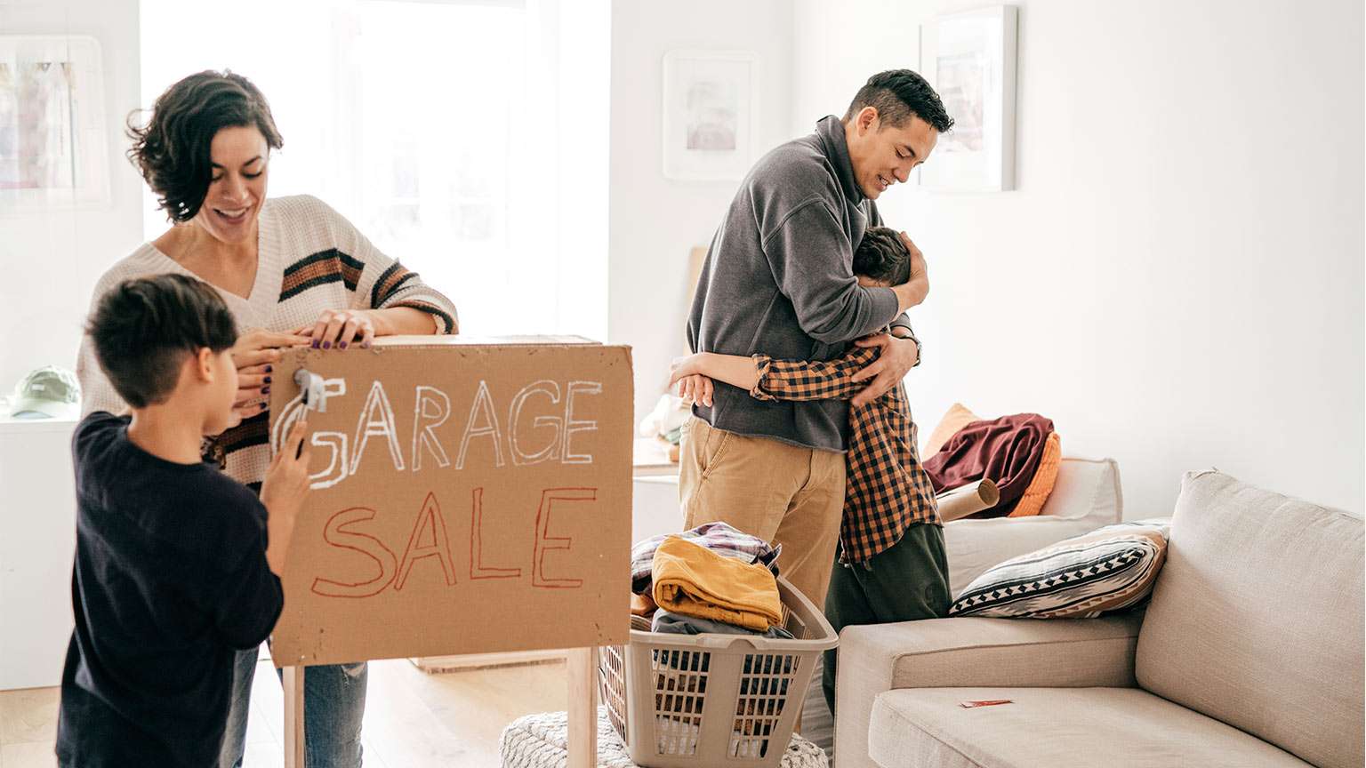 family painting garage sale sign in their living room