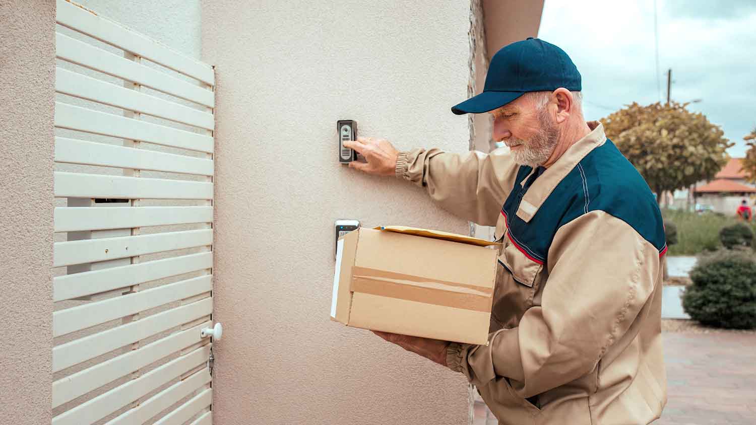 A delivery worker ringing a doorbell