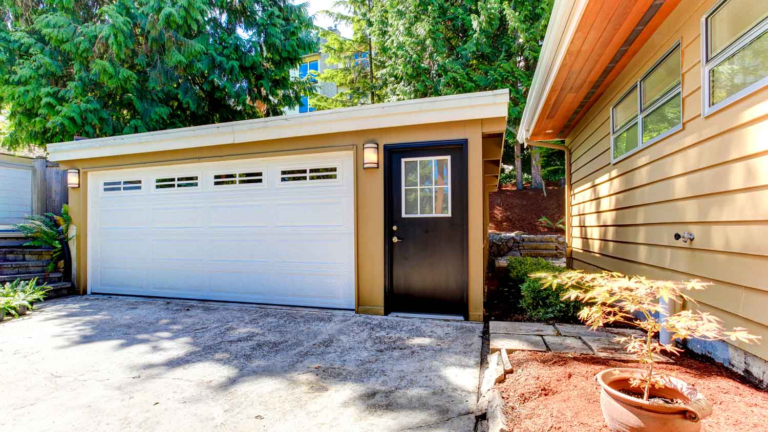 Concrete driveway with a detached garage