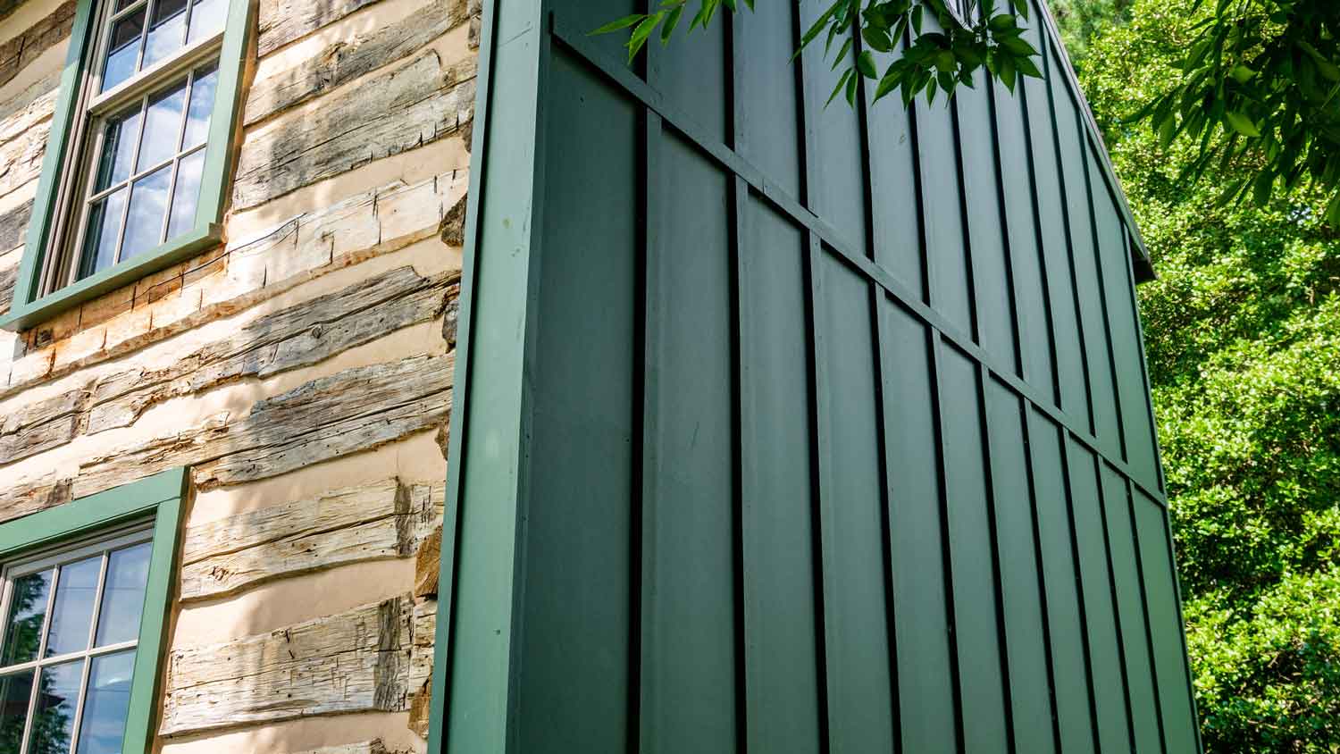 Detail of the Hardie board siding on a log cabin