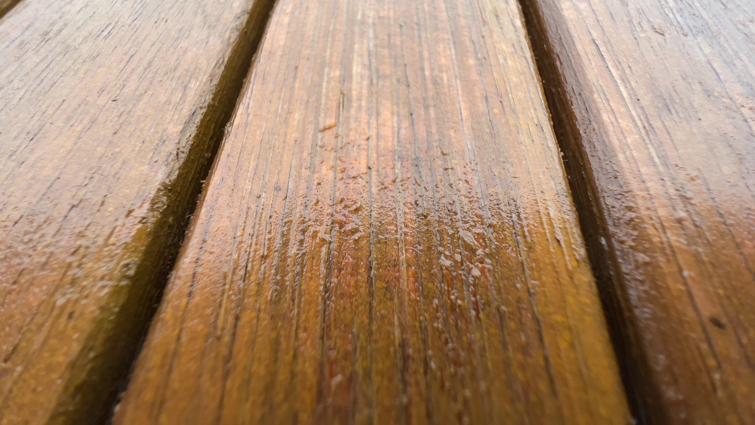 Wet light wood of a garden table